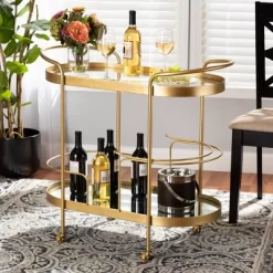Kamal Glam Brushed Metal And Mirrored Glass 2 Tier Mobile Wine Bar Cart Gold - Baxton Studio -Online Furniture Store GUEST 034e04a5 db63 474b 9d05 6c159816da1c